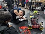 Student adjusting Robot